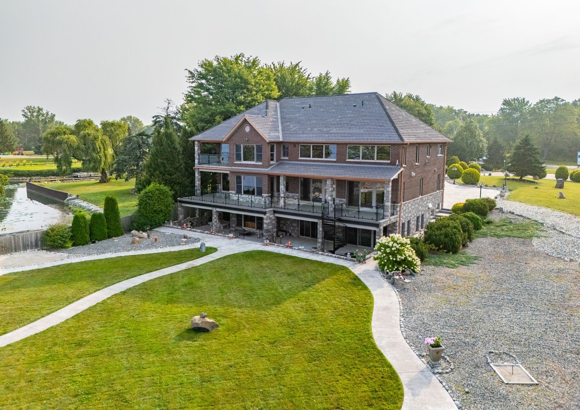 Drone view of 1360 Windermere Place and the surrounding riverfront